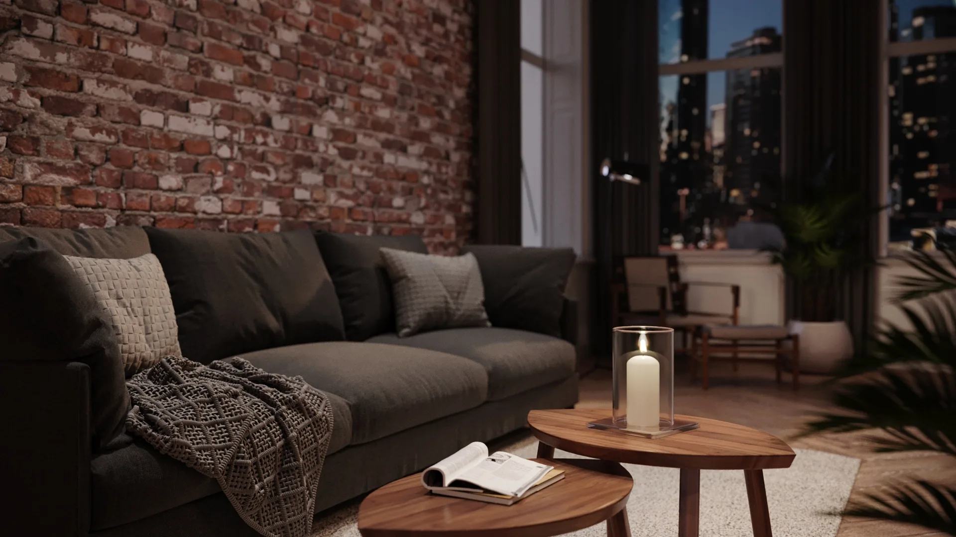 A candle in a glass cylinder on a timber coffee table beside a dark sofa, with a brick wall and city windows behind.