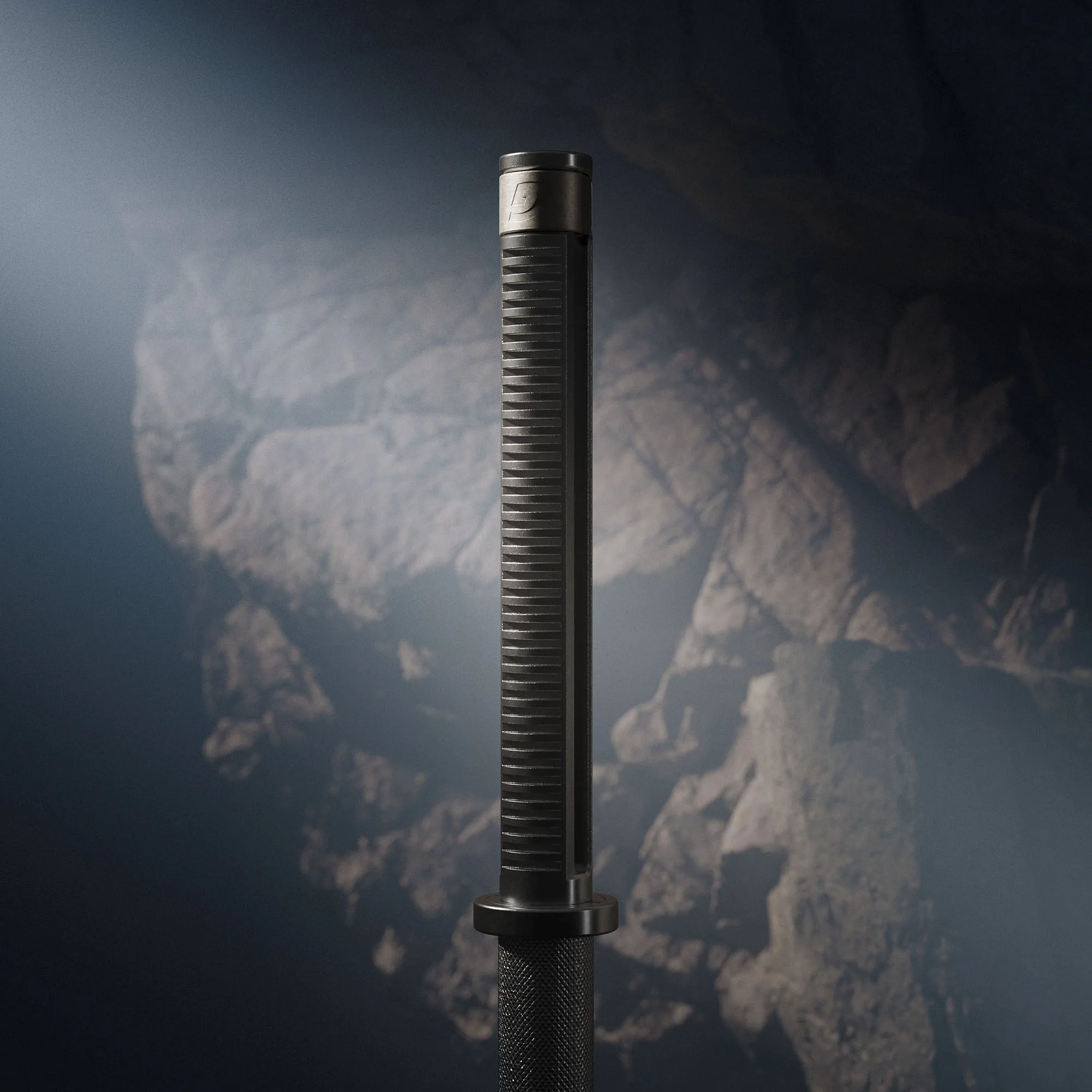 Close view of a dark barbell sleeve, with fine highlights across its grooves and a softly defined rocky background.